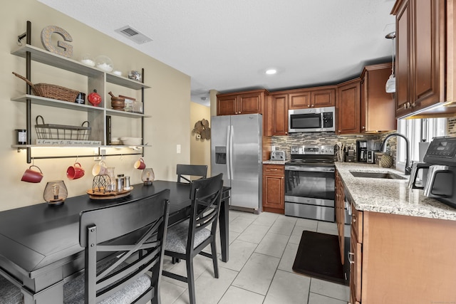 15 Arlington Rd, Windsor Locks, CT 06096 - kitchen featuring stainless steel appliances, decorative backsplash, light stone counters, open shelves, and recessed lighting