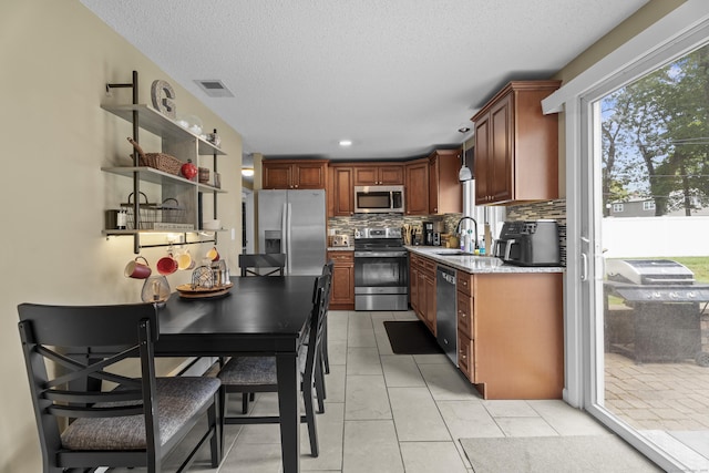 15 Arlington Rd, Windsor Locks, CT 06096 - kitchen with stainless steel appliances, backsplash, light countertops, a textured ceiling, and open shelves