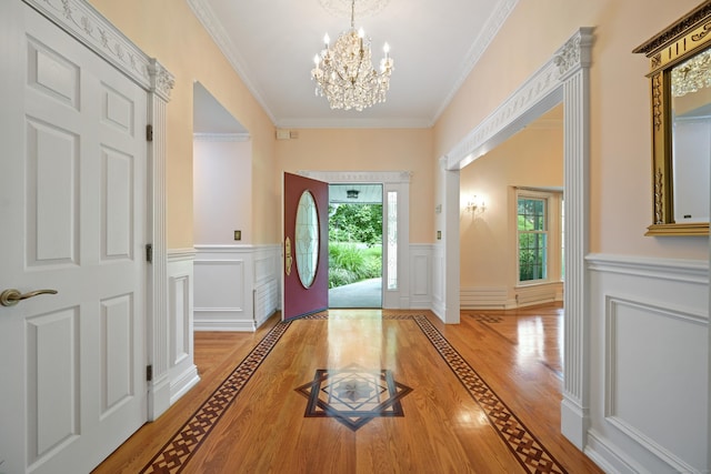 9 Old Logging Rd, Stamford, CT 06903 - entrance foyer with light wood-style flooring, healthy amount of natural light, a chandelier, a wainscoted wall, and a decorative wall