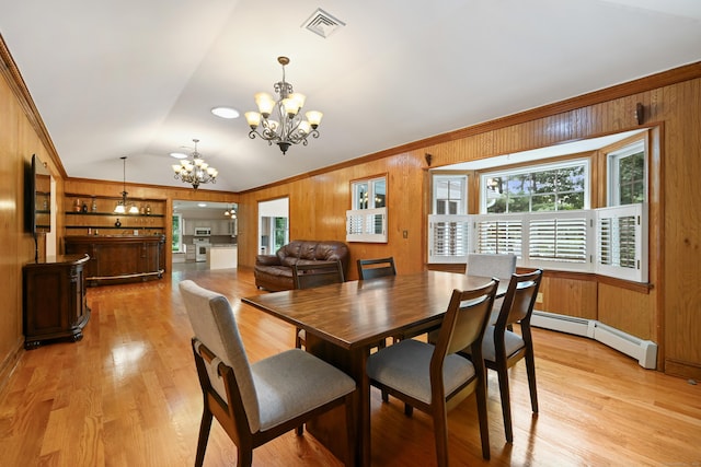 9 Old Logging Rd, Stamford, CT 06903 - dining space featuring a chandelier, vaulted ceiling, wooden walls, a baseboard heating unit, and light wood-style floors
