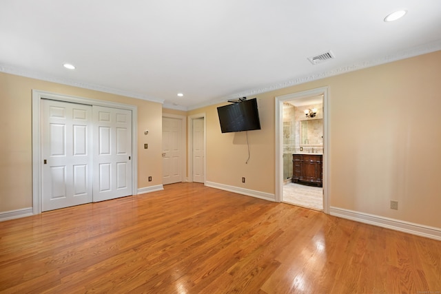 9 Old Logging Rd, Stamford, CT 06903 - unfurnished bedroom with recessed lighting, light wood-type flooring, multiple closets, crown molding, and connected bathroom