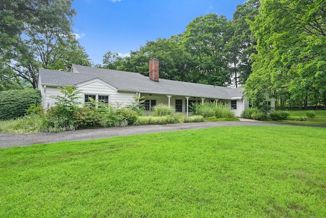 9 Old Logging Rd, Stamford, CT 06903 - ranch-style house with a front lawn, driveway, and a chimney