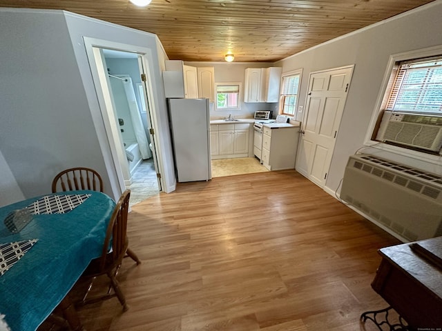 37 Lane St, Shelton, CT 06484 - kitchen with freestanding refrigerator, plenty of natural light, light countertops, white cabinets, and wood ceiling