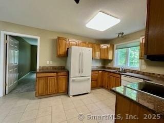 1929 Logans Way, Windsor, CT 06095 - kitchen with freestanding refrigerator, brown cabinets, and dark countertops