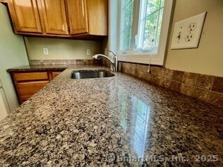 1929 Logans Way, Windsor, CT 06095 - kitchen featuring light stone countertops and brown cabinetry