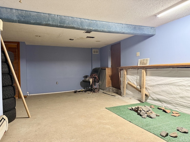 17 Ohear Ave, Enfield, CT 06082 - finished below grade area featuring a baseboard heating unit, a textured ceiling, and carpet floors