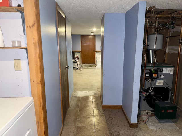 17 Ohear Ave, Enfield, CT 06082 - corridor with washer / clothes dryer, a heating unit, and a textured ceiling