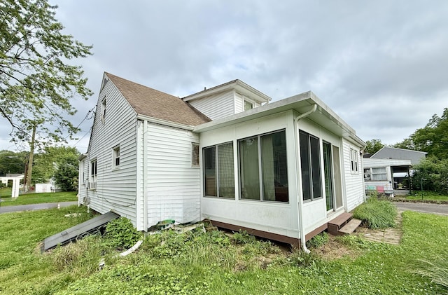 17 Ohear Ave, Enfield, CT 06082 - view of side of property with a sunroom, a yard, and a shingled roof