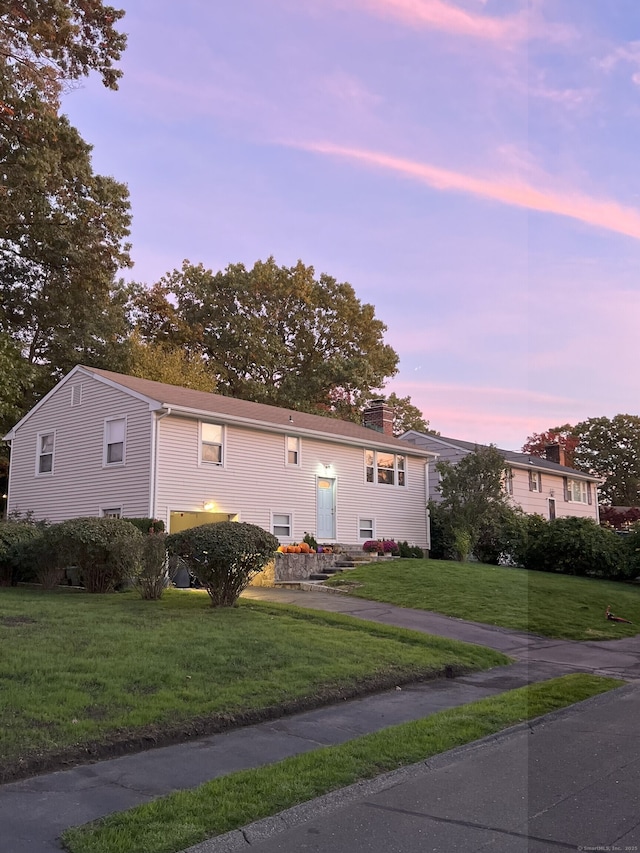 66 Valley View Rd, Norwalk, CT 06851 - bi-level home with a lawn and a chimney