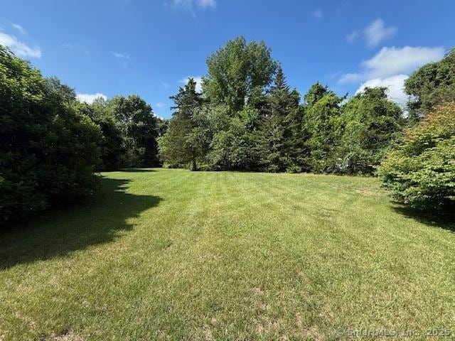 67 Bergendahl Dr, Griswold, CT 06351 - view of green lawn featuring a view of trees