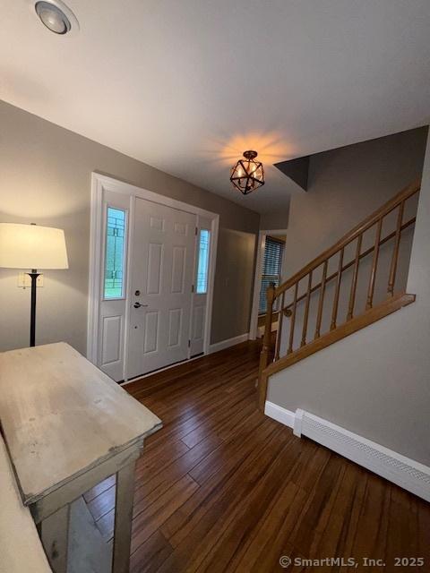 67 Bergendahl Dr, Griswold, CT 06351 - entryway featuring stairs, baseboard heating, and wood finished floors