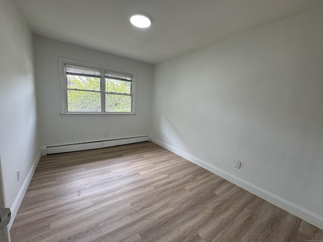 10 Willowbrook Ct Unit 10, Stamford, CT 06902 - empty room with a baseboard radiator and wood finished floors
