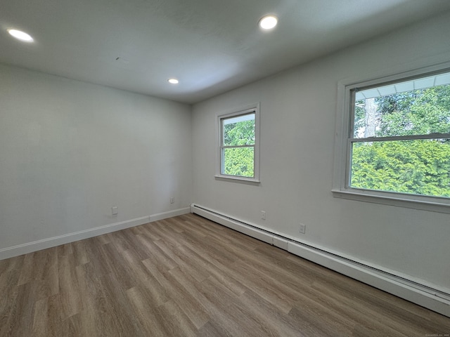 10 Willowbrook Ct Unit 10, Stamford, CT 06902 - spare room featuring a baseboard heating unit, wood finished floors, and recessed lighting
