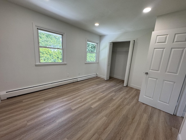 10 Willowbrook Ct Unit 10, Stamford, CT 06902 - unfurnished bedroom featuring a baseboard radiator, wood finished floors, recessed lighting, and a closet