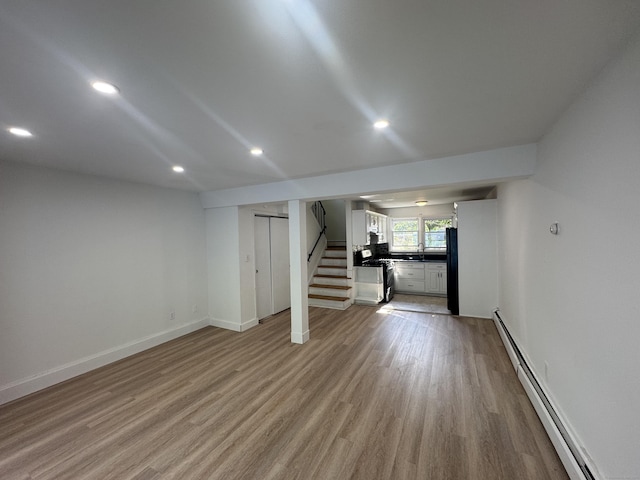 10 Willowbrook Ct Unit 10, Stamford, CT 06902 - basement featuring baseboard heating, wood finished floors, stairway, and recessed lighting