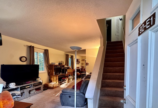 92 Cynthia Ln Apt E1, Middletown, CT 06457 - living room featuring a textured ceiling, carpet, and stairway