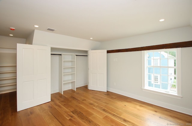 65 Water St, Guilford, CT 06437 - unfurnished bedroom with light wood finished floors, recessed lighting, and a closet