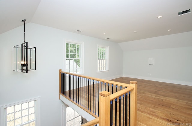65 Water St, Guilford, CT 06437 - hallway featuring lofted ceiling, wood finished floors, recessed lighting, a chandelier, and an upstairs landing