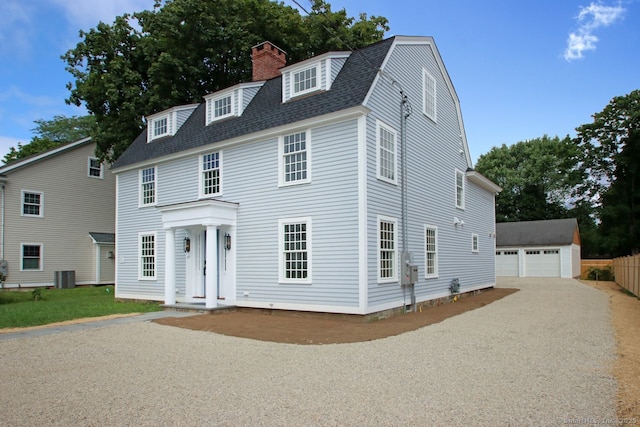 65 Water St, Guilford, CT 06437 - colonial inspired home featuring a gambrel roof, an outdoor structure, roof with shingles, a chimney, and a detached garage