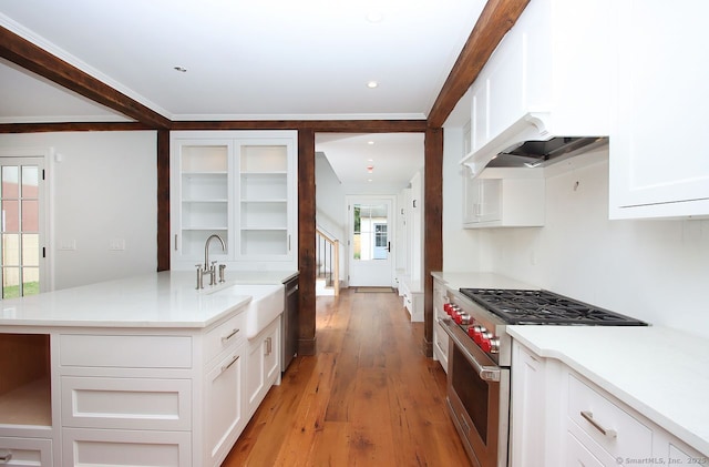 65 Water St, Guilford, CT 06437 - kitchen featuring stainless steel appliances, white cabinets, light wood-style floors, light countertops, and crown molding