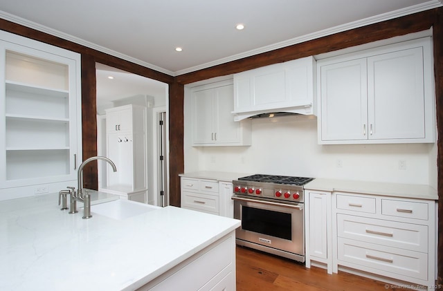 65 Water St, Guilford, CT 06437 - kitchen with premium range, white cabinetry, custom range hood, crown molding, and open shelves