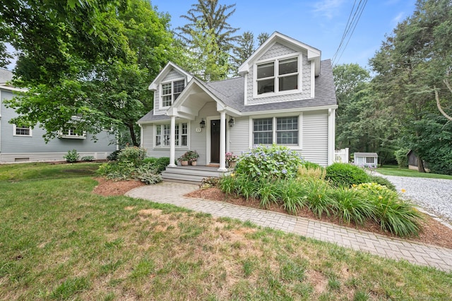 73 Water St, Glastonbury, CT 06073 - new england style home with a front lawn and roof with shingles