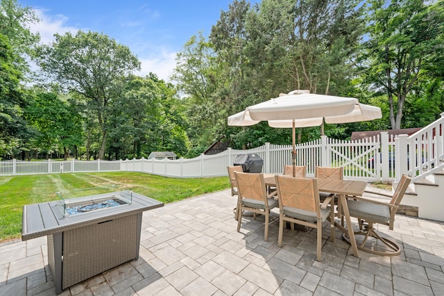 73 Water St, Glastonbury, CT 06073 - fenced backyard with a fire pit, a patio, outdoor dining space, and view of scattered trees