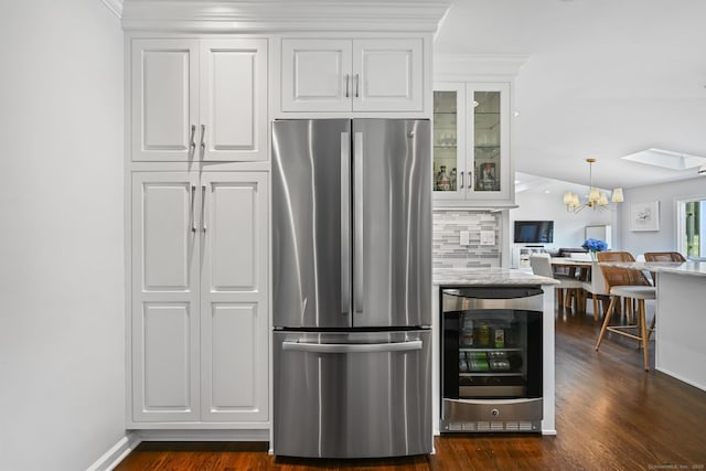 68 William St, Norwalk, CT 06851 - kitchen featuring freestanding refrigerator, a chandelier, beverage cooler, glass insert cabinets, and white cabinetry