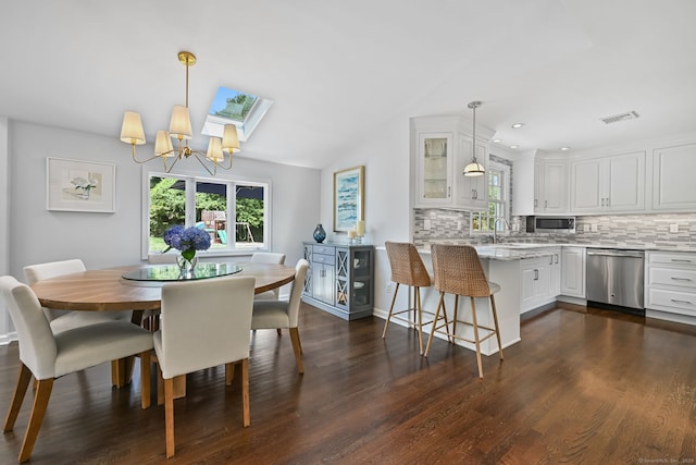 68 William St, Norwalk, CT 06851 - dining room featuring healthy amount of natural light, a chandelier, dark wood-style floors, recessed lighting, and vaulted ceiling