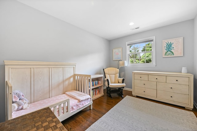 68 William St, Norwalk, CT 06851 - bedroom featuring dark wood-type flooring, recessed lighting, and a crib