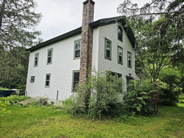 16AND23 Farrell Rd, Newtown, CT 06470 - view of property exterior with a chimney and a yard