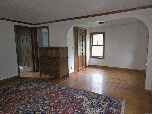 16AND23 Farrell Rd, Newtown, CT 06470 - spare room featuring arched walkways, ornamental molding, and wood finished floors
