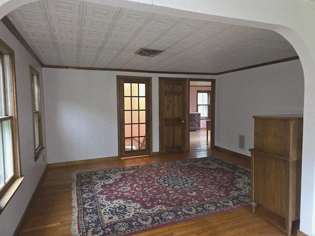 16AND23 Farrell Rd, Newtown, CT 06470 - spare room featuring ornamental molding, wood finished floors, arched walkways, and an ornate ceiling