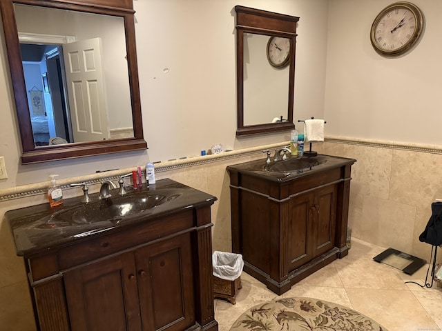 300 Foxon Hill Rd, East Haven, CT 06513 - bathroom with tile walls, two vanities, a wainscoted wall, and tile patterned flooring