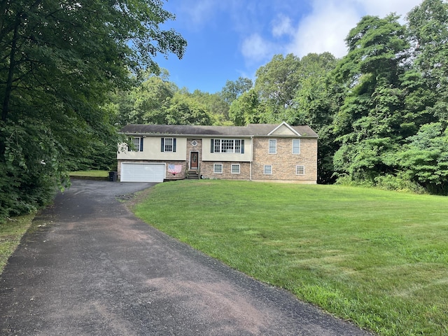 300 Foxon Hill Rd, East Haven, CT 06513 - raised ranch featuring a garage, a front lawn, and asphalt driveway