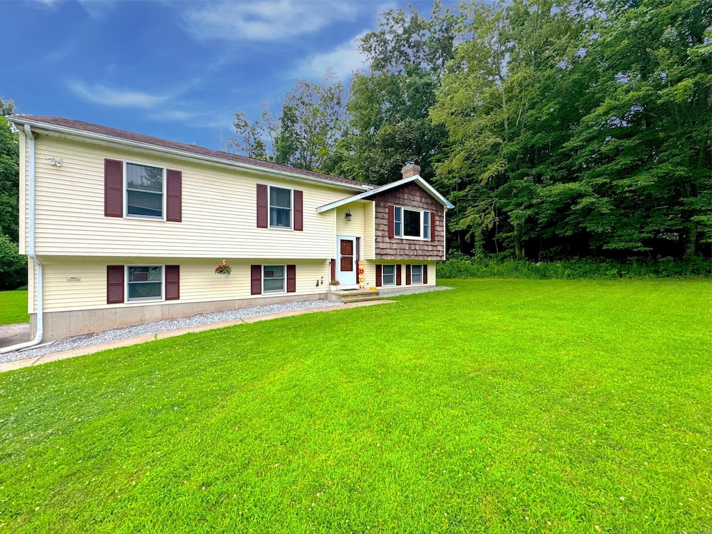 406 Windham Ave, Colchester, CT 06415 - raised ranch with a front lawn and a chimney