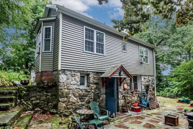 52 Hudson Dr, New Fairfield, CT 06812 - back of property featuring stone siding and a patio area