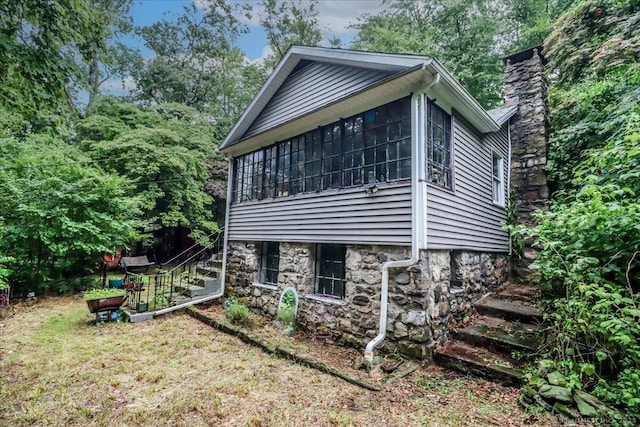 52 Hudson Dr, New Fairfield, CT 06812 - view of property exterior featuring stairway, a chimney, and a sunroom