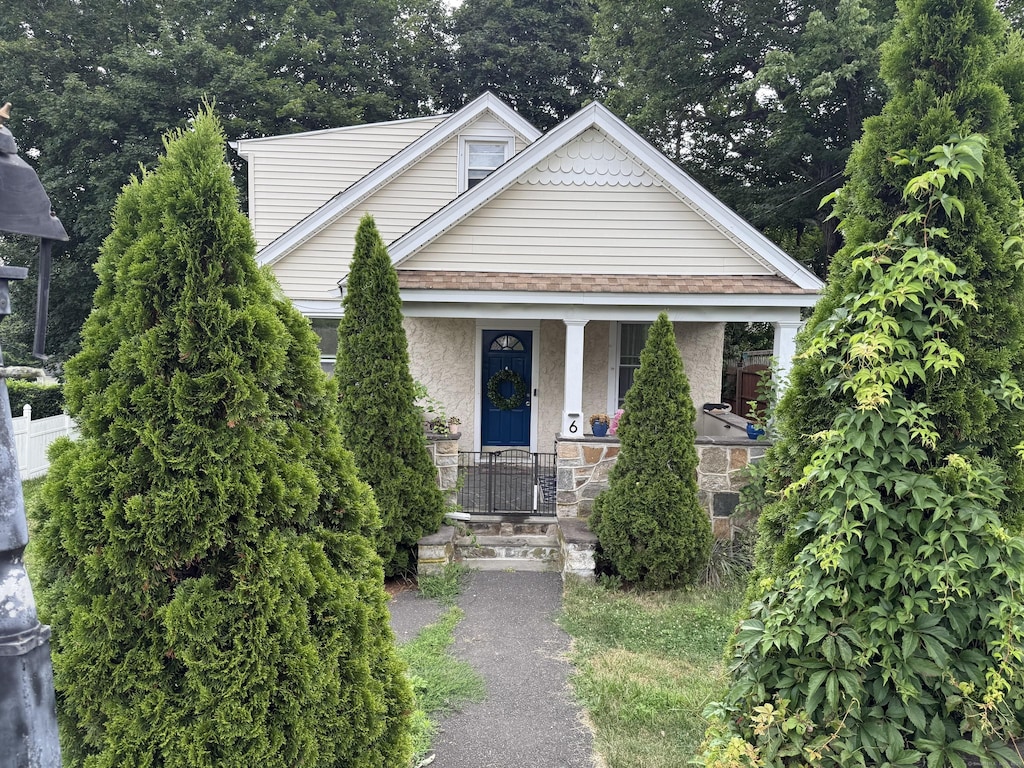 6 Lane Ave, Trumbull, CT 06611 - bungalow-style home with covered porch, roof with shingles, stucco siding, and stone siding