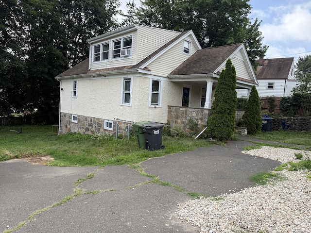 6 Lane Ave, Trumbull, CT 06611 - view of property exterior featuring a shingled roof, stucco siding, and cooling unit