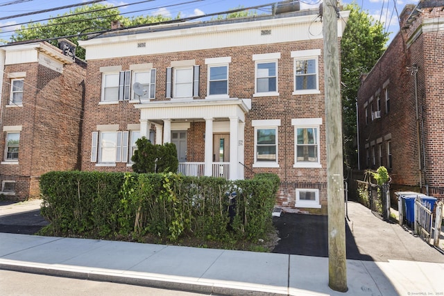 276 Bond St, Bridgeport, CT 06610 - view of front of property featuring brick siding and covered porch