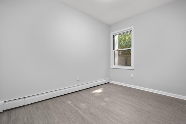 276 Bond St, Bridgeport, CT 06610 - empty room with a baseboard radiator and wood finished floors