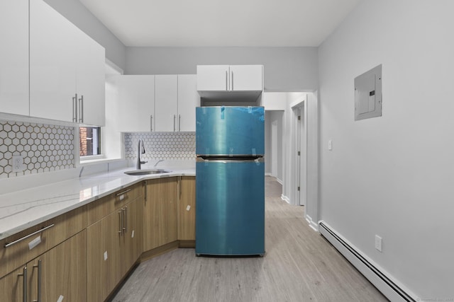 276 Bond St, Bridgeport, CT 06610 - kitchen with freestanding refrigerator, electric panel, a baseboard radiator, light wood finished floors, and white cabinets
