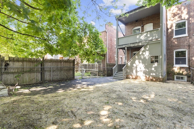 276 Bond St, Bridgeport, CT 06610 - rear view of house featuring brick siding and a balcony