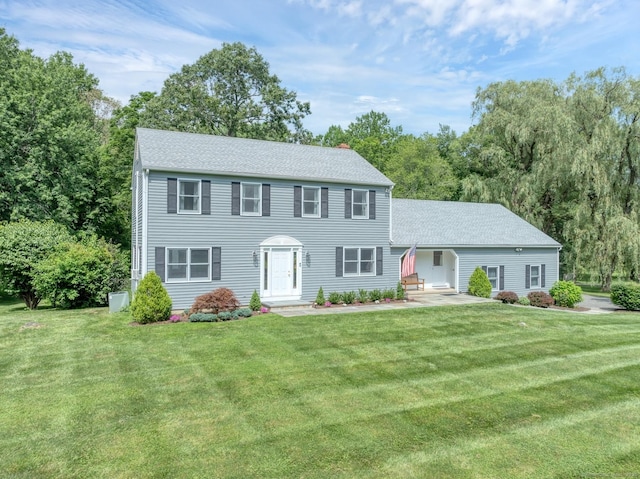 35 Pheasant Ln, Ridgefield, CT 06877 - colonial home featuring a front lawn, a shingled roof, and a chimney