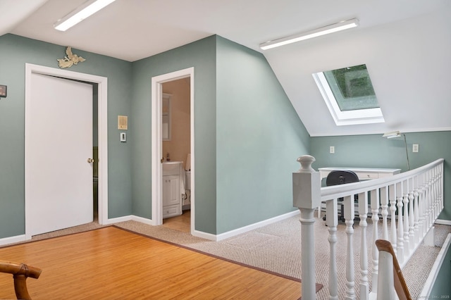35 Pheasant Ln, Ridgefield, CT 06877 - entryway featuring a skylight, lofted ceiling, wood finished floors, and carpet flooring