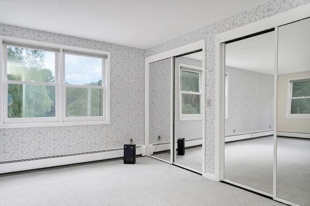 35 Pheasant Ln, Ridgefield, CT 06877 - unfurnished bedroom with wallpapered walls, multiple closets, carpet flooring, and baseboard heating