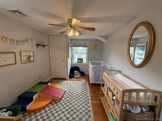 19 Hartford Ave, Old Saybrook, CT 06475 - bedroom featuring a textured ceiling, wood finished floors, and a ceiling fan