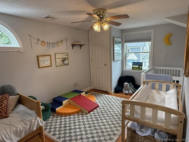 19 Hartford Ave, Old Saybrook, CT 06475 - bedroom featuring wood finished floors, a textured ceiling, and a ceiling fan