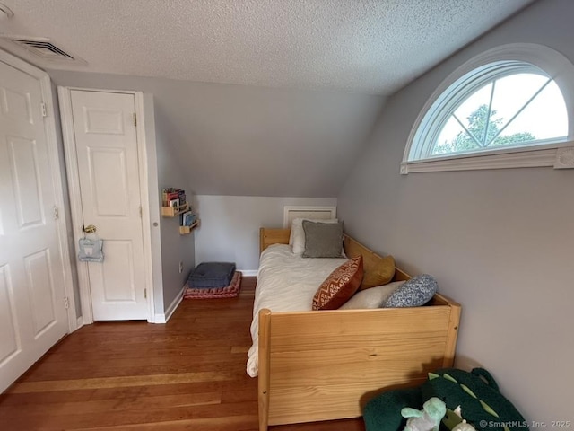 19 Hartford Ave, Old Saybrook, CT 06475 - bedroom with a textured ceiling, wood finished floors, and lofted ceiling